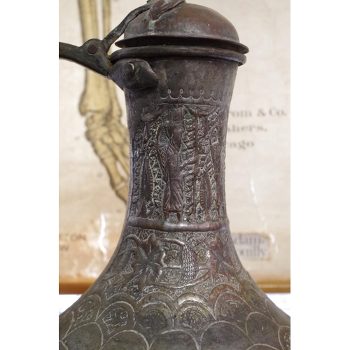 1176 - A large Islamic silvered copper jug, 55cm high; together with three others.