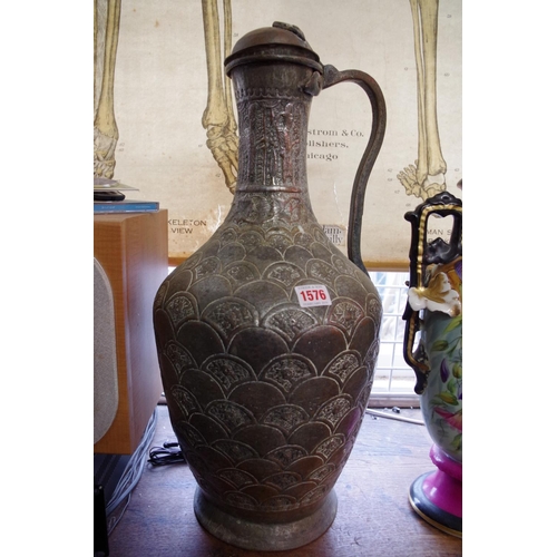 1176 - A large Islamic silvered copper jug, 55cm high; together with three others.