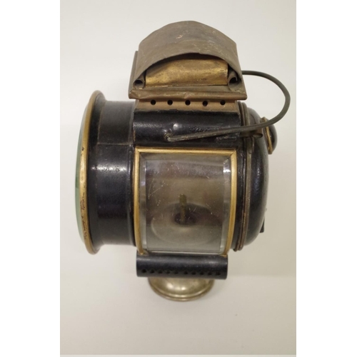 501 - An early 20th century brass and blackened metal oil headlamp, height including handle 31cm.... 