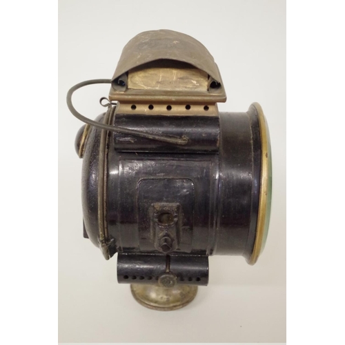 501 - An early 20th century brass and blackened metal oil headlamp, height including handle 31cm.... 