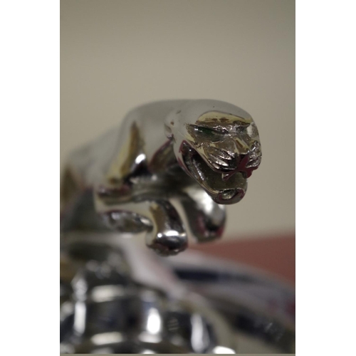 569 - A Jaguar Cars chrome plated leaping cat ashtray, 12cm high.