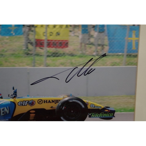 598 - Photographs: a colour image of Fernando Alonso in Renault, signed, 23.5 x 20cm.