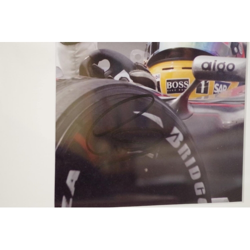 603 - Photographs: a colour image of Lewis Hamilton in Mercedes, signed, image 22 x 15cm.