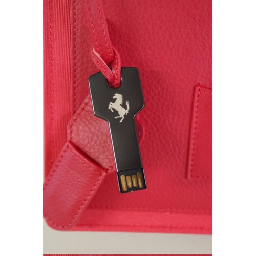 637 - Ferrari: an FF red leather 'New Owner's Welcome Pack', with branded drawstring dust bag, boxed; toge... 