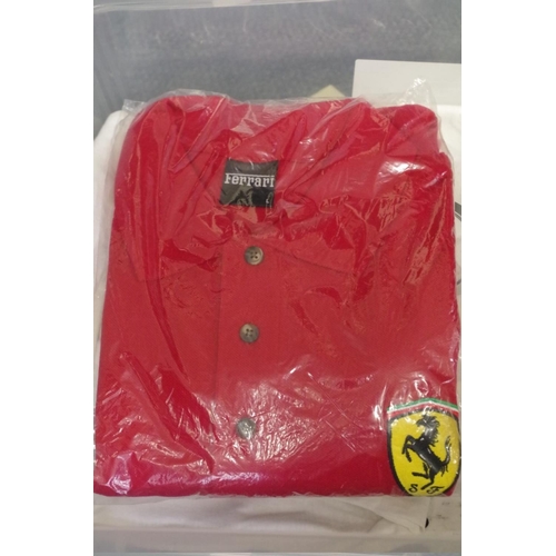 663 - A collection of shirts and caps, to include: an official Ferrari polo shirt; and a Rolex cap.... 