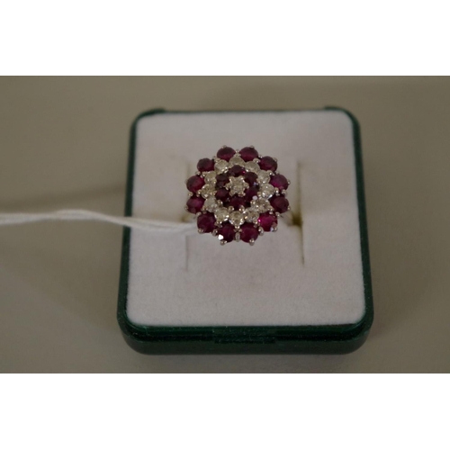 105 - An unmarked diamond and garnet cocktail cluster ring, 7g all in.