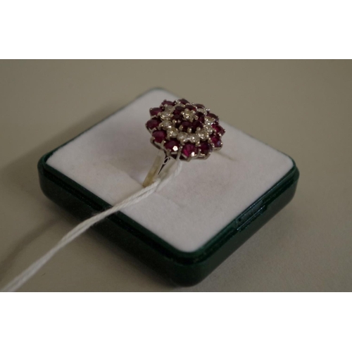 105 - An unmarked diamond and garnet cocktail cluster ring, 7g all in.