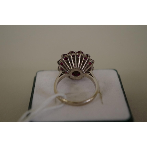 105 - An unmarked diamond and garnet cocktail cluster ring, 7g all in.