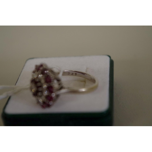 105 - An unmarked diamond and garnet cocktail cluster ring, 7g all in.