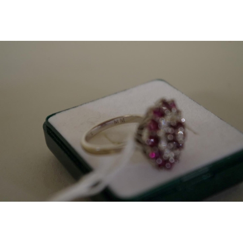 105 - An unmarked diamond and garnet cocktail cluster ring, 7g all in.