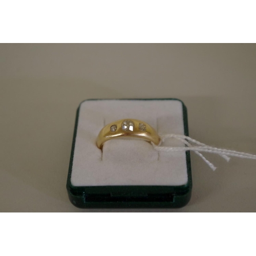 110 - An 18ct gold three stone diamond gypsy set ring, 6.9g all in.