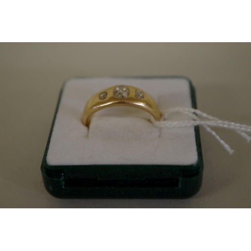 110 - An 18ct gold three stone diamond gypsy set ring, 6.9g all in.