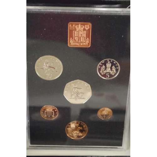 222 - Three cased British decimal coin sets, 1970, 1971 and 1977; together with a silver proof Guernsey Ro... 