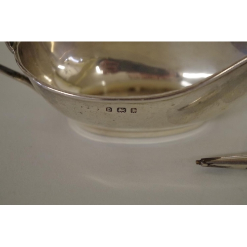 66 - A group of silver items, to include a pair of small sauce boats, Birmingham 1905 and a silver ring c... 