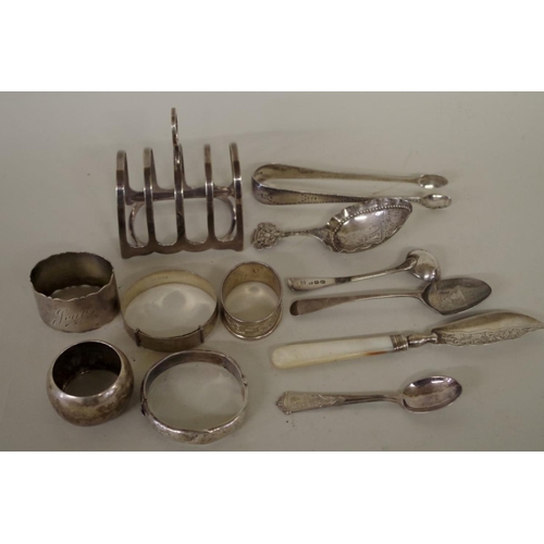 70 - A mixed group of silver, to include: a pair of silver Georgian sugar tongs; two silver bangles; and ... 