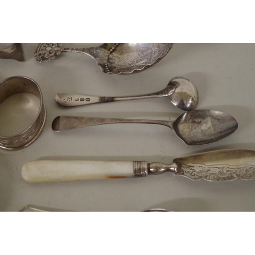 70 - A mixed group of silver, to include: a pair of silver Georgian sugar tongs; two silver bangles; and ... 