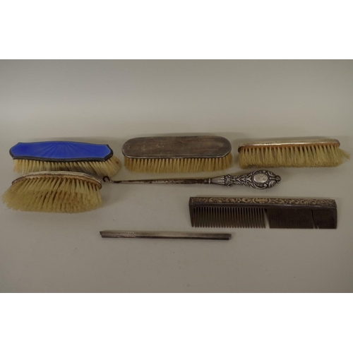 77 - Four various silver brushes; together with two silver comb slides; and a silver handled button hook.... 