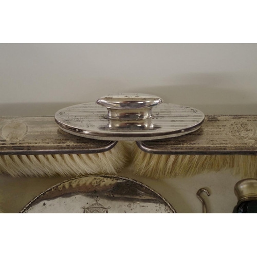 78 - An engine turned silver three piece dressing table brush set; together with a silver hand mirro... 