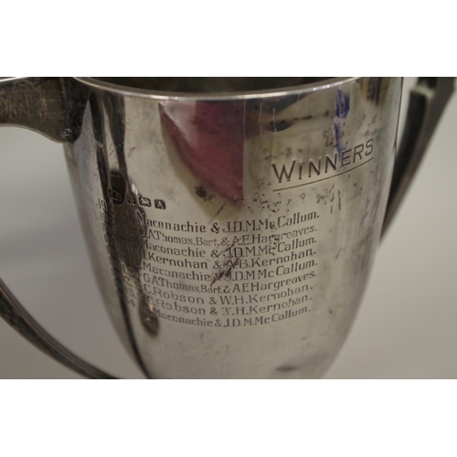 81 - A silver twin handled trophy cup, by Fattorini & Sons, Sheffield 1927, 21cm; together with ... 