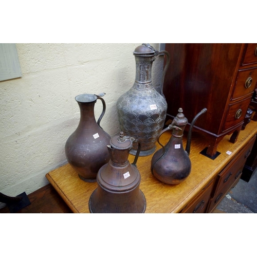 1176 - A large Islamic silvered copper jug, 55cm high; together with three others.