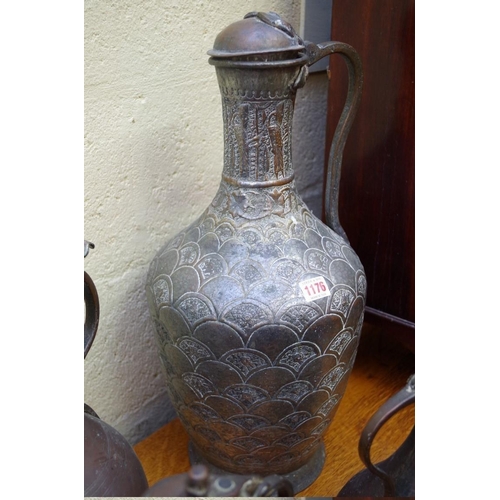 1176 - A large Islamic silvered copper jug, 55cm high; together with three others.