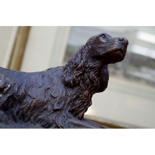 1181 - A bronze figure group of two gun dogs, 27cm wide.