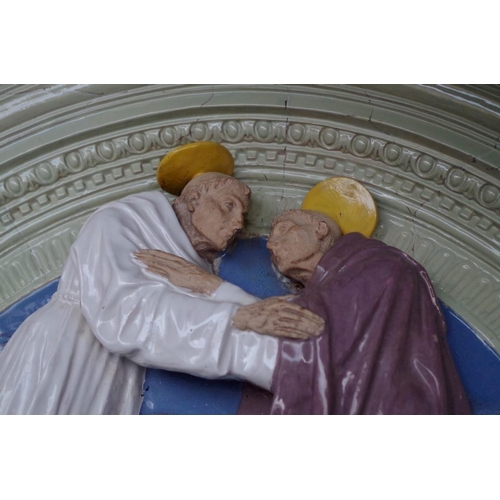 1213 - A Cantagalli arched relief plaque of two saints, 69.5cm wide.