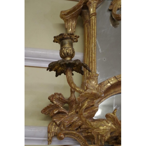 1710 - A pair of 18th century rococo carved giltwood girandoles, 75.5 x 43cm, with gilt metal sconces.... 