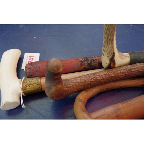 1741 - A collection of sticks and canes, to include a bamboo cane; two antler handled riding crops; an... 