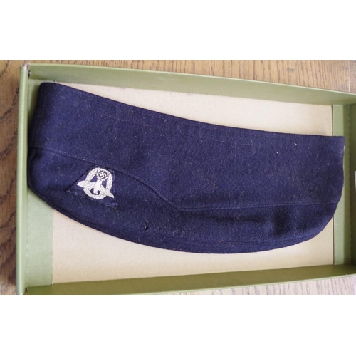 1756 - A German Third Reich navy blue felt overseas police side cap, with cloth badge.... 