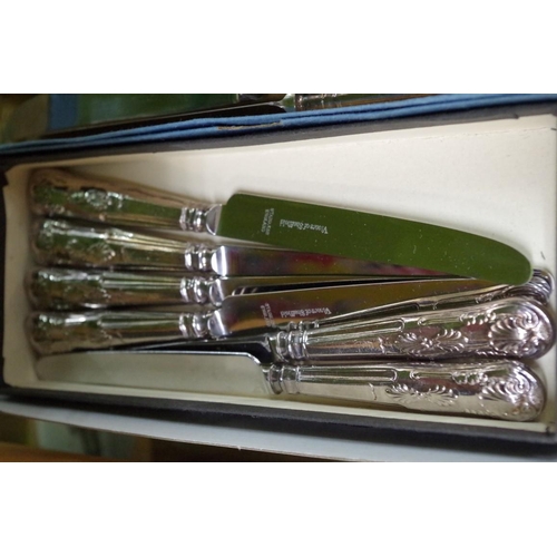 87 - Six silver plated soup spoons; together with twelve Kings pattern stainless steel knives; and a Vict... 