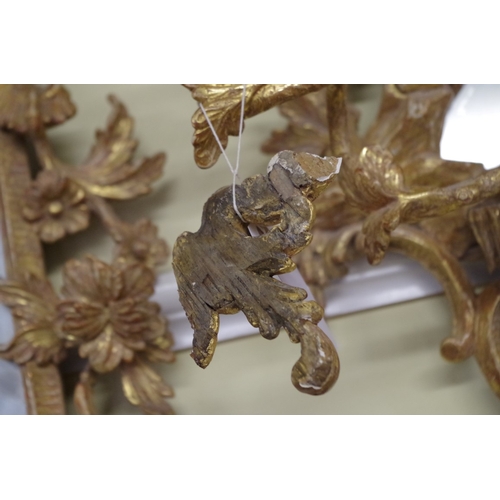 1710 - A pair of 18th century rococo carved giltwood girandoles, 75.5 x 43cm, with gilt metal sconces.... 