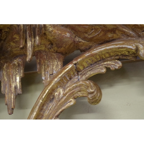 1710 - A pair of 18th century rococo carved giltwood girandoles, 75.5 x 43cm, with gilt metal sconces.... 