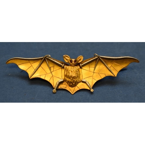 89 - An unmarked yellow &amp; white gold bat brooch, having cabochon ruby eyes, 6cm.