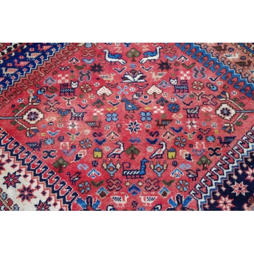 1102 - A Persian rug, having six floral and geometric medallions to central field and floral and bird ... 