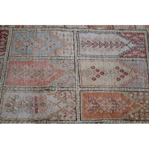 1104 - A Persian rug, having panel design allover with floral and geometric borders, 167 x 60cm.... 