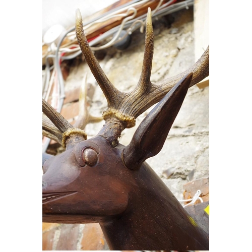 1110 - A Folk Art carved and painted wood stag's head, with a pair of natural ten pointed antlers.... 