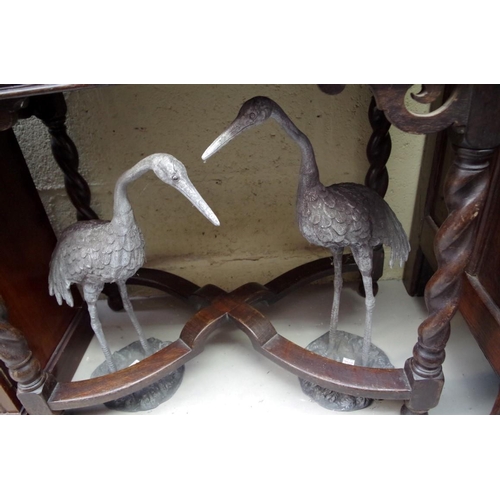 1169 - A pair of lead models of cranes, largest 57.5cm high.