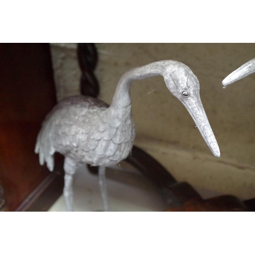 1169 - A pair of lead models of cranes, largest 57.5cm high.