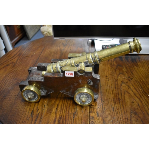 1726 - A pair of 19th century brass starting cannons, 38cm long, each on mahogany four wheel carriage.... 