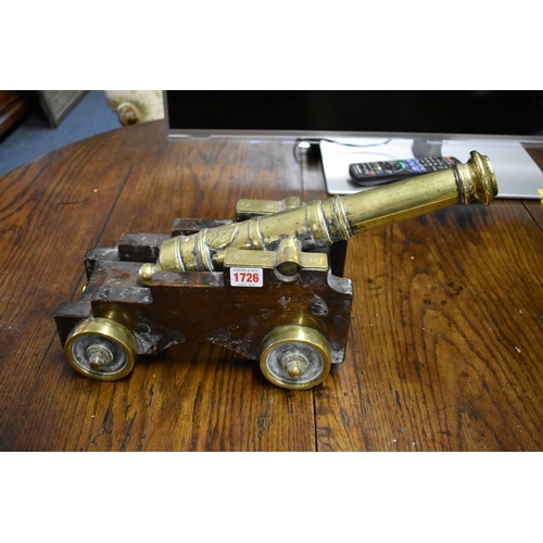 1726 - A pair of 19th century brass starting cannons, 38cm long, each on mahogany four wheel carriage.... 