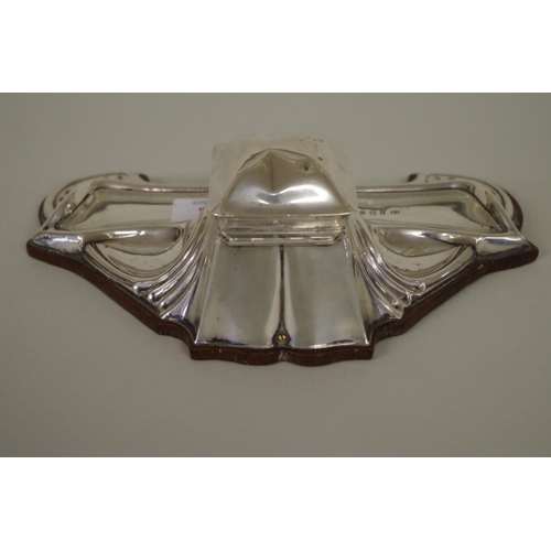 21 - An Art Nouveau silver inkstand, by William Neale, Birmingham 1911, mounted on wooden base, 20cm.... 