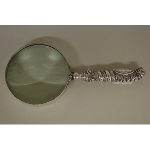 24 - A large magnifying glass in unmarked mount, 27cm overall length.