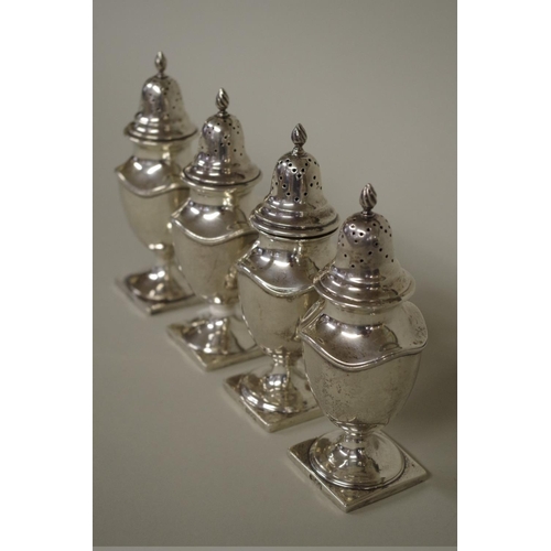 29 - Four silver pepperettes, one by Goldsmiths & Silversmiths Co, London 1906; the other t... 
