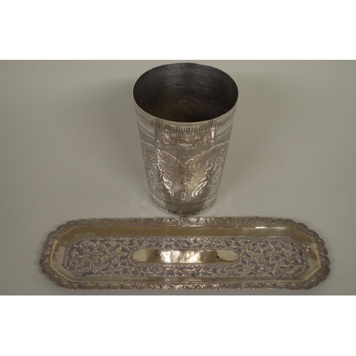 78 - A metal beaker decorated figures, 11cm high; together with a metal pin tray, 22.5cm long. *Please no... 