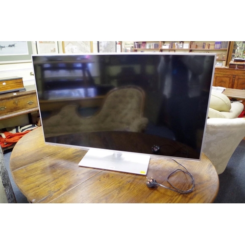 1755 - A Panasonic TX-L42E6B television, with remote control, (light surface scratches to screen).... 