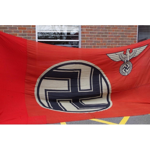 1728 - A German Third Reich large Swastika flag, 290 x 490cm, (the left hand side is slightly different col... 