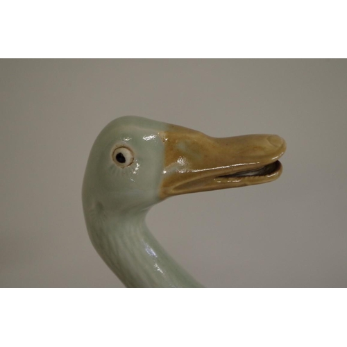 550 - Four Chinese celadon glazed geese, largest 23.5cm. (4)