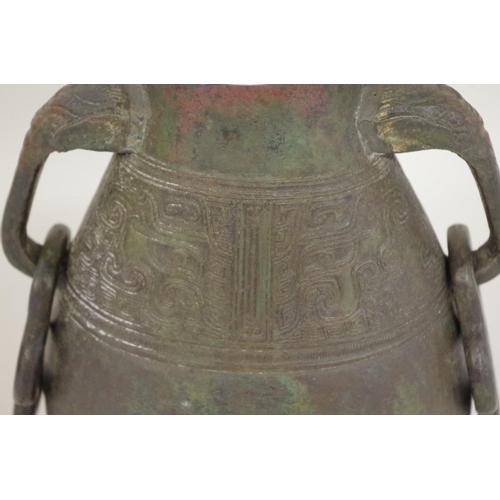 560 - A Chinese Archaistic bronze style twin handled vase, probably Ming or earlier, 29.5cm high.... 