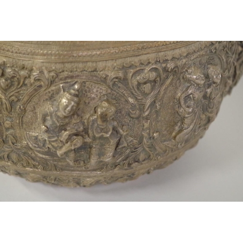 569 - An Indian white metal bowl, 19th century, embossed with panels of figures, 24cm diameter, 1157g.... 